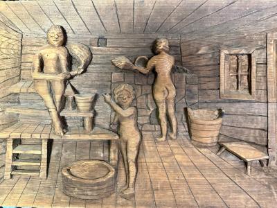 Wood carving of a sauna scene